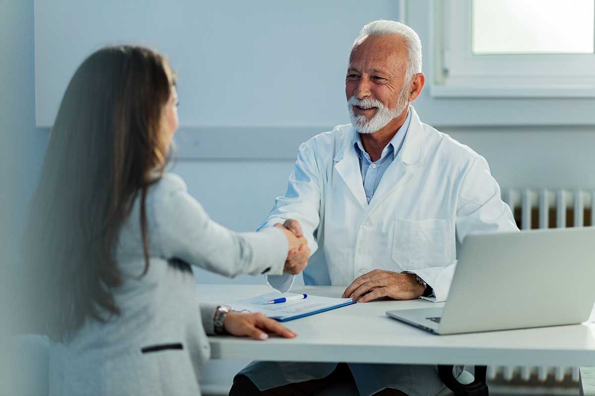 Doctor and patient shaking hands after a clinic appointment